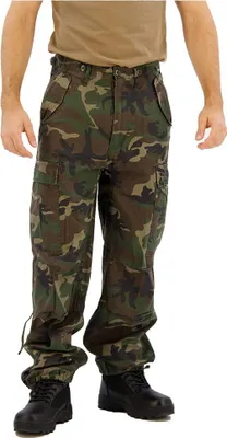 A person wearing camouflage cargo pants and black boots, standing against a white background.