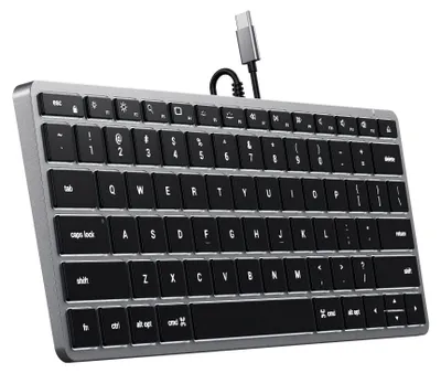 A close-up, angled view of a silver and black wired keyboard with a USB-C connector.