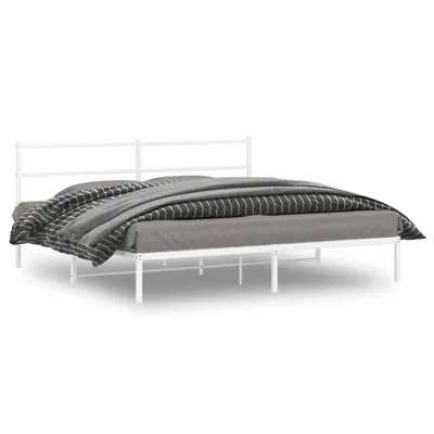 A white metal bed frame with a headboard, covered with bedding, is shown against a white background.