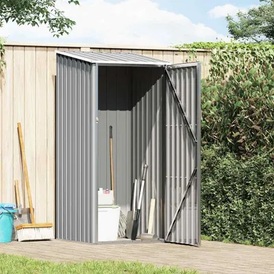 A grey metal garden shed with its door open, showing gardening tools inside and leaning against the outside.