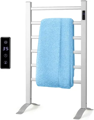 A white electric towel warmer with a blue towel draped over it, and a separate remote control.