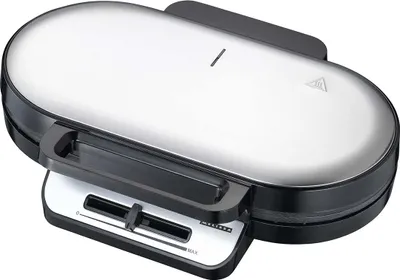 A silver and black oval-shaped waffle maker shown from a slight angle.