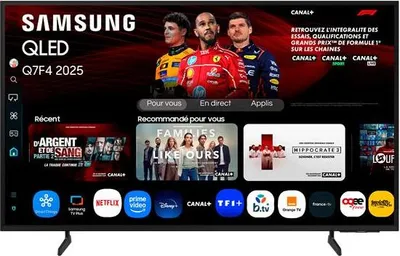 A Samsung QLED TV displaying a promotional screen with images of Formula 1 drivers and various app icons.