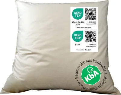A white pillow with several certification labels on it.
