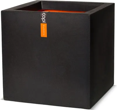 A black square planter with an orange interior and a label on the side.