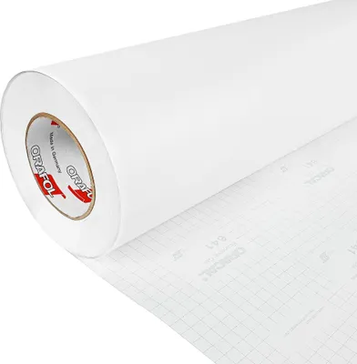 A roll of white matte adhesive film, partially unrolled to show the grid-lined backing paper.