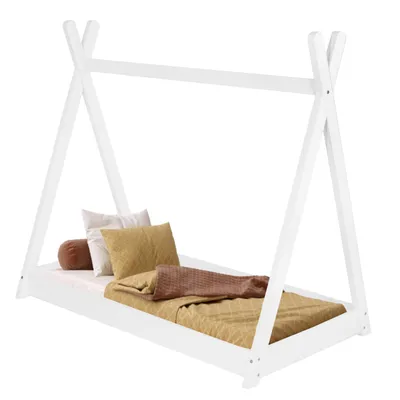 A white tipi-style children's bed with bedding and pillows.