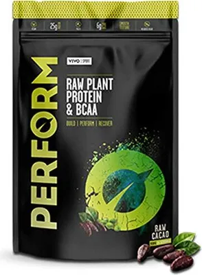 A black pouch of vegan protein powder with green and yellow accents, placed on a white background. There are also some cacao beans and leaves in the foreground.