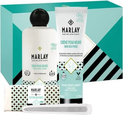 A gift set of Marlay skincare products, including a bottle, a tube, a cloth, and a nail file, presented in a teal and white patterned box.