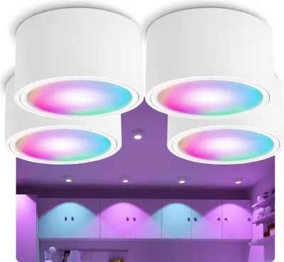 Four white ceiling lights with colorful LED lights are shown, with a purple background and cabinets below illuminated by colored lights.