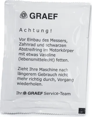 A small white packet with instructions printed on it.