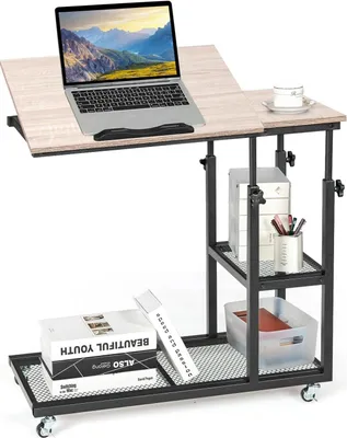A laptop table with a laptop, books, and a cup on it, set against a white background.