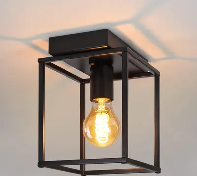 A black metal cage ceiling light with a vintage-style Edison bulb.