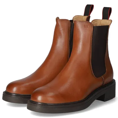 A pair of brown Chelsea boots on a white background.