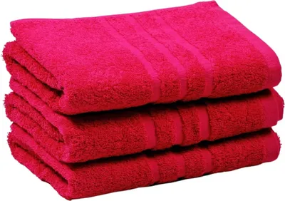 A stack of three folded pink towels.