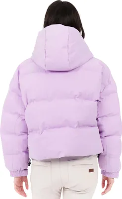 Back view of a woman wearing a purple puffer jacket and beige pants.