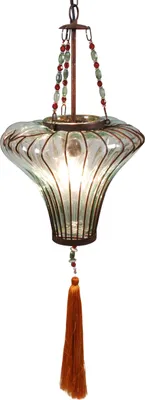 A hanging lamp with a glass shade and a tassel.
