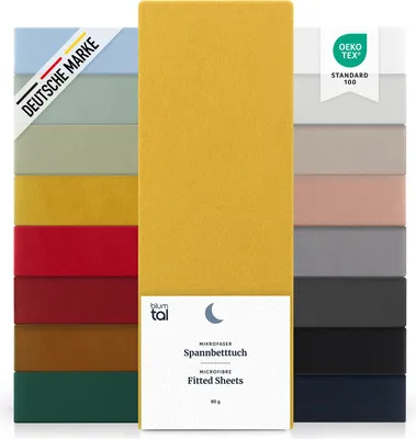 A display of multiple fitted sheets in various colors, with a central focus on a yellow sheet and its packaging.