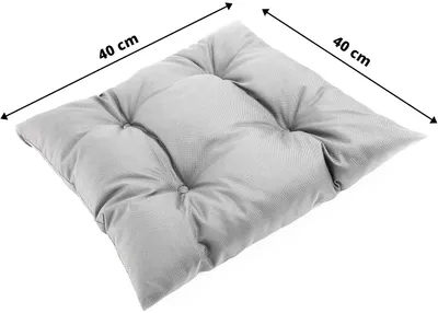 A light gray square cushion with tufted buttons, shown from a diagonal angle.