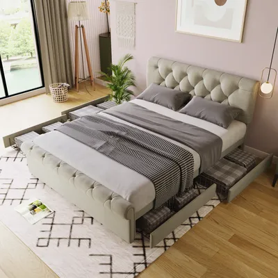 A bedroom scene featuring a tufted bed with open storage drawers.