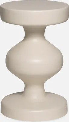 A single, cream-colored side table with a unique hourglass shape.