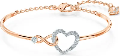 A rose gold bracelet with an infinity symbol and a heart charm, adorned with clear crystals, is displayed on a white background.