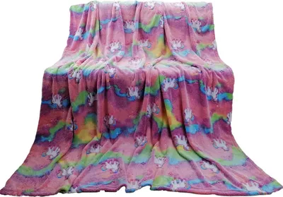 A fluffy blanket with a unicorn and rainbow pattern is draped over a surface.