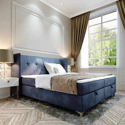 A bedroom scene featuring a blue boxspring bed.