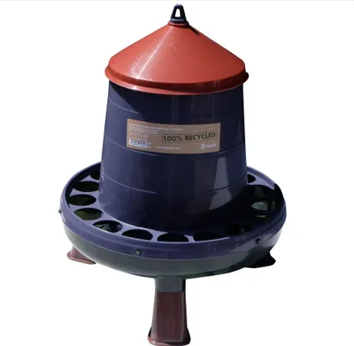 A dark blue chicken feeder with a red lid and brown legs, standing on a white background.