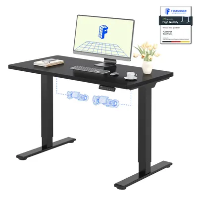 A black standing desk with a computer monitor, keyboard, mouse, and a vase of flowers.