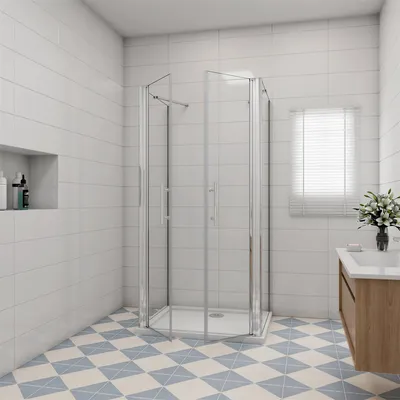 A modern bathroom with a corner shower enclosure, vanity, and tiled walls and floor.