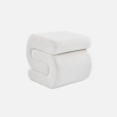 A white bouclé ottoman is shown against a white background.