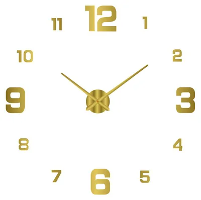 A gold-colored 3D DIY wall clock with numbers and hands on a white background.