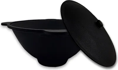 A black cast iron pot with its lid slightly ajar, presented on a white background.