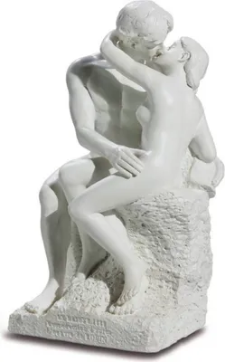 A white sculpture of a couple kissing, seated on a rock.