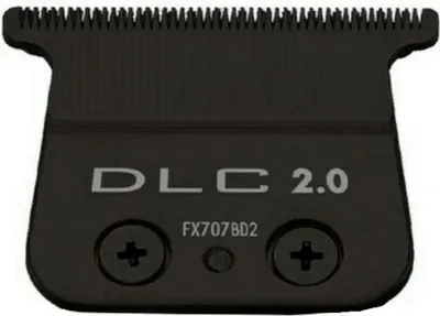 A close-up of a black hair trimmer blade with text.