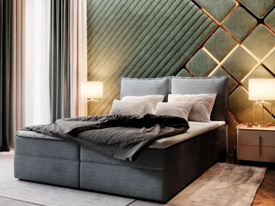A bedroom scene featuring a large boxspring bed with a dark gray upholstered base and headboard, dressed with gray bedding and white pillows. The wall behind the bed has a distinctive quilted green panel design with illuminated geometric accents. Two bedsi
