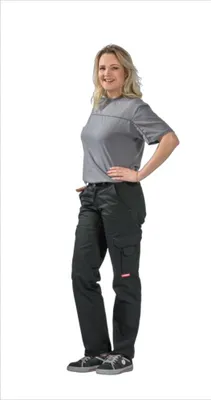 A woman is standing and posing in a studio setting, wearing the product.