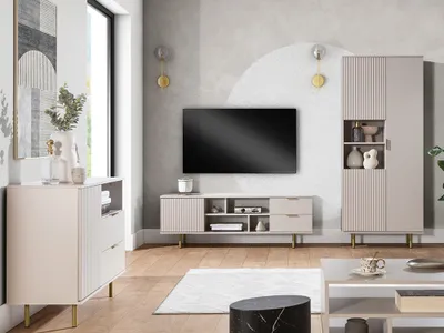 A modern living room with a TV, media console, and storage units.