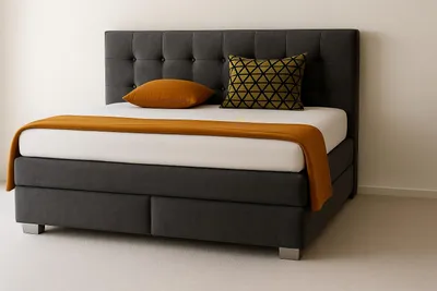 A bed with a headboard, mattress, and bedding in a room.