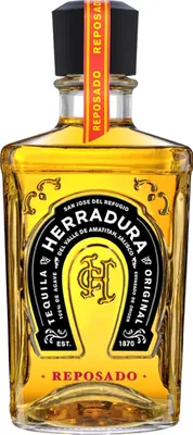 A bottle of Herradura Reposado Tequila against a white background.