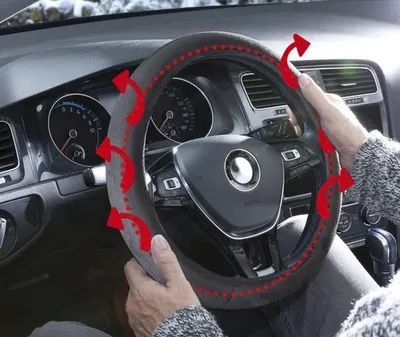 Hands holding a steering wheel cover inside a car.
