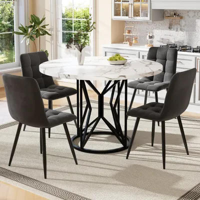 A round dining table with four chairs in a kitchen setting.