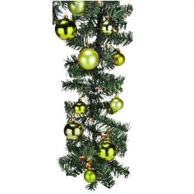 A close-up shot of a green Christmas garland decorated with lime green baubles.