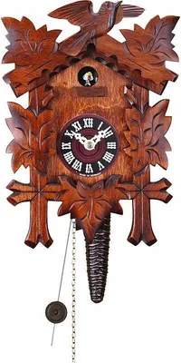 A cuckoo clock with intricate carvings of leaves and a bird on top.