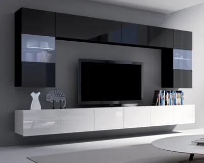 A modern living room wall unit with a television and storage cabinets.