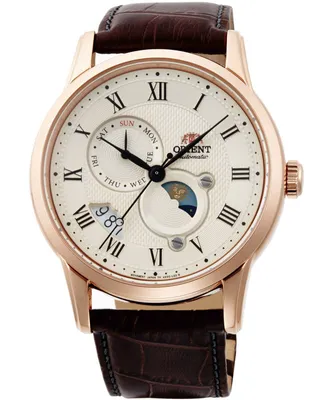 A close-up studio shot of a men's watch with a white dial, Roman numerals, and a brown leather strap.