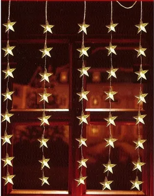 A string of star-shaped LED lights hanging in front of a window.