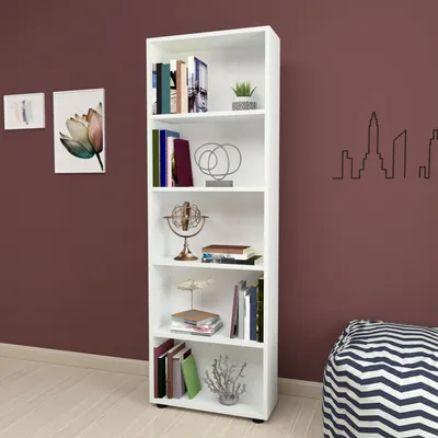 A white bookshelf filled with books and decorative items, placed against a dark brown wall.