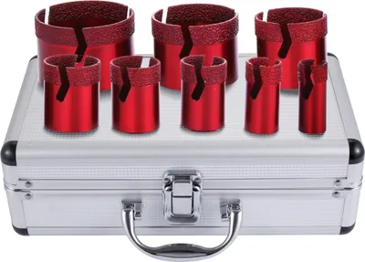 A set of red diamond drill bits in a silver carrying case.